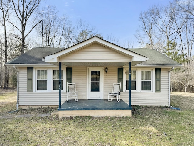 bungalow-style house with a front lawn and a porch