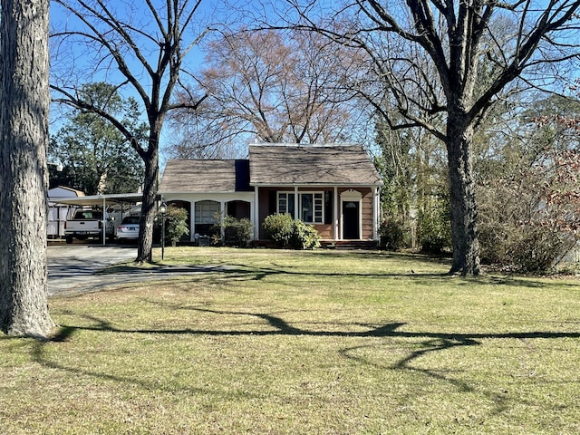 view of front of property with a front yard and a carport