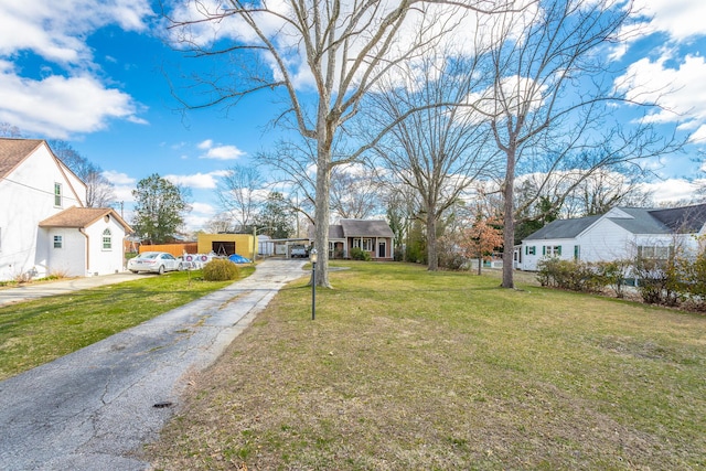 view of yard featuring driveway and a residential view