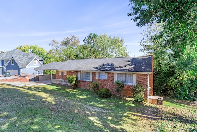 ranch-style house featuring an attached carport, brick siding, and a front lawn