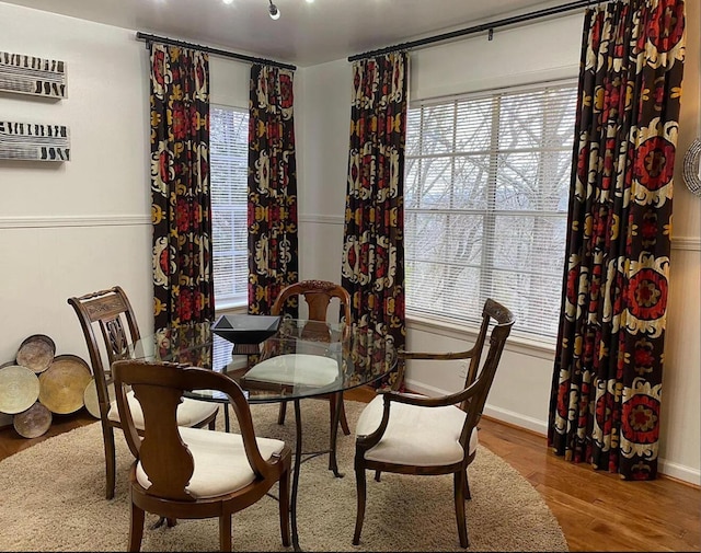 dining space featuring plenty of natural light and wood finished floors