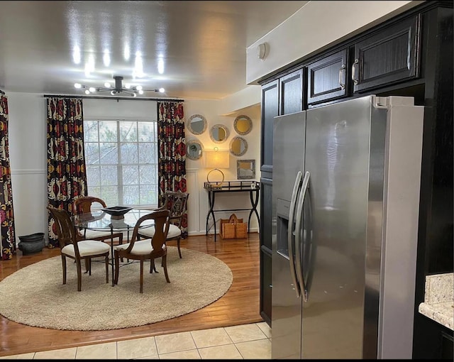 dining room featuring an inviting chandelier and light tile patterned floors