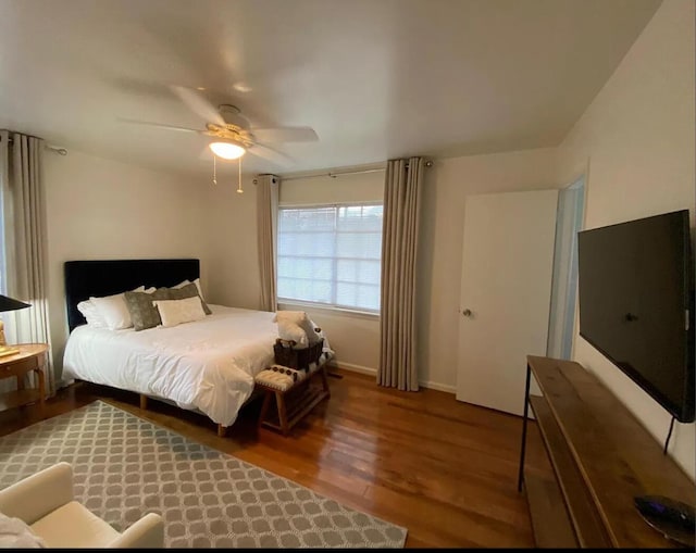 bedroom featuring baseboards, a ceiling fan, and wood finished floors