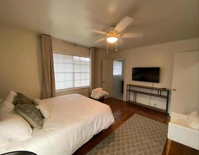 bedroom with ceiling fan and dark wood-type flooring