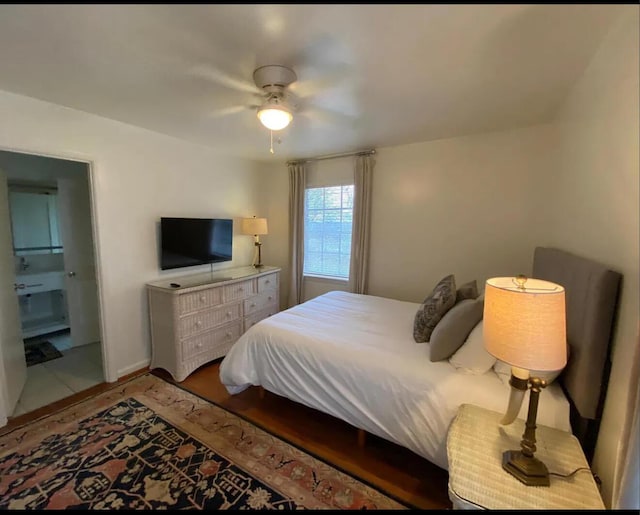 bedroom with ceiling fan and connected bathroom