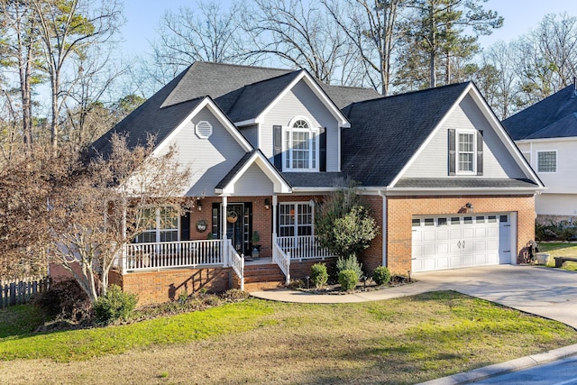 view of front of home with covered porch, a front lawn, and a garage