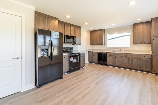 79 Bear Oak Dr, Dunlap, TN 37327 - kitchen with black appliances, a sink, light wood-style floors, ornamental molding, and light countertops