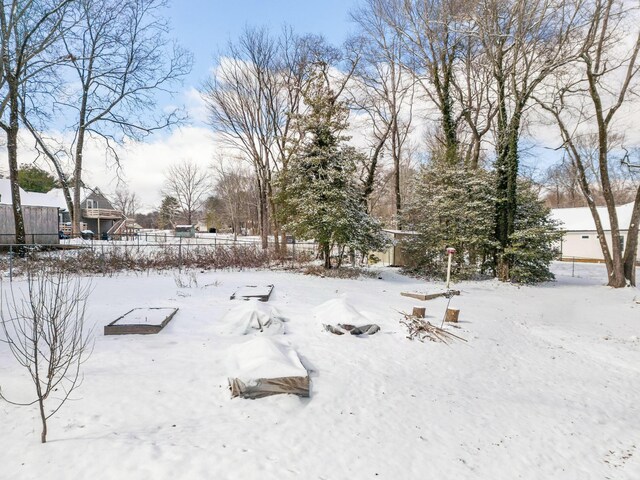 yard layered in snow featuring fence