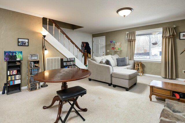 carpeted living area featuring visible vents, crown molding, baseboards, and stairs