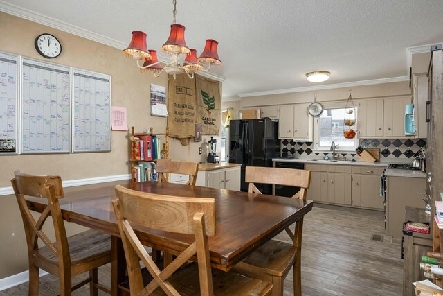 dining space with a textured ceiling, baseboards, dark wood-style flooring, and crown molding