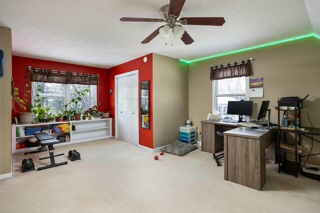 home office featuring light carpet, baseboards, and a textured ceiling