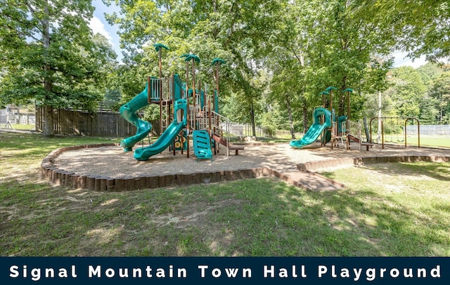 community jungle gym with fence and a lawn