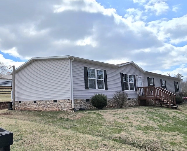 view of home's exterior with crawl space and a lawn