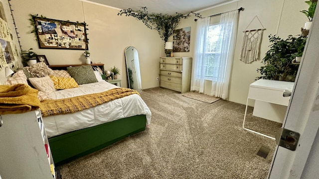 carpeted bedroom featuring visible vents