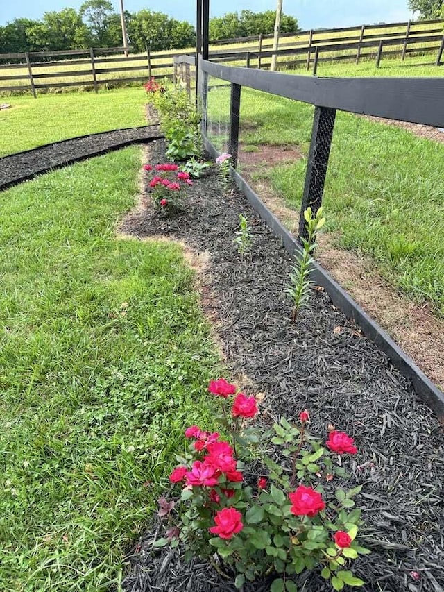 view of yard featuring a rural view and fence