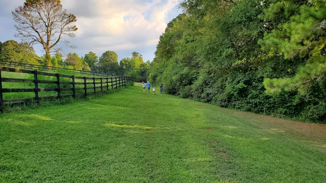 view of yard featuring fence and a rural view