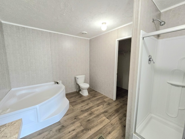 full bath with a textured ceiling, a stall shower, wood finished floors, and crown molding