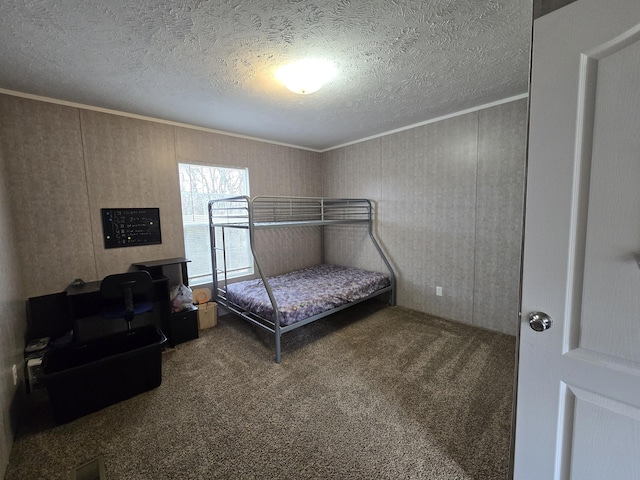 bedroom featuring a textured ceiling, ornamental molding, carpet, and visible vents