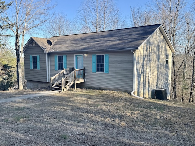 ranch-style home with roof with shingles and cooling unit