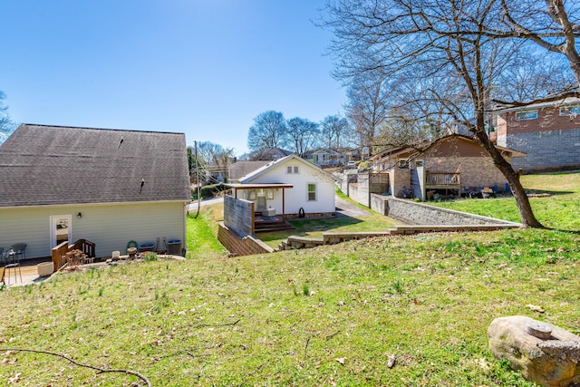 back of house with a lawn and a deck