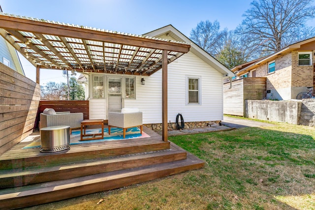 deck featuring a lawn, fence, and a pergola