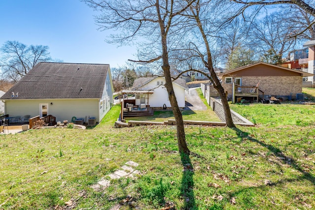 view of yard with central AC and a wooden deck