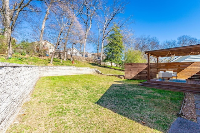 view of yard with fence and a deck