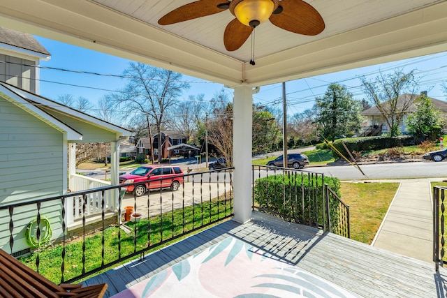 deck with a ceiling fan, a residential view, and covered porch