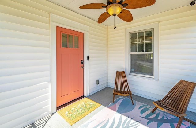 view of exterior entry with a ceiling fan