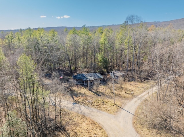 drone / aerial view featuring a forest view