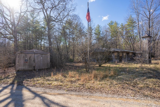 view of yard with an outbuilding and a storage shed