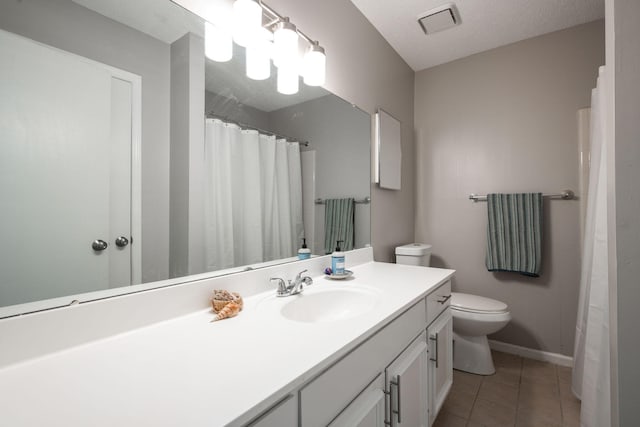 bathroom featuring toilet, visible vents, baseboards, vanity, and tile patterned floors