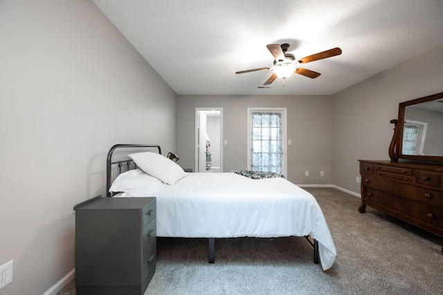 carpeted bedroom featuring a ceiling fan, a textured ceiling, and baseboards