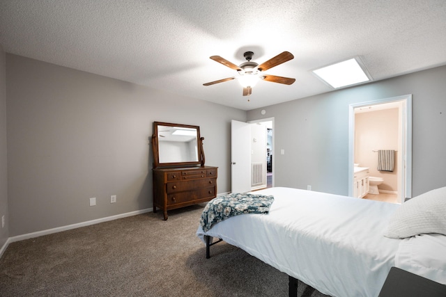 carpeted bedroom featuring a textured ceiling, ceiling fan, ensuite bathroom, and baseboards