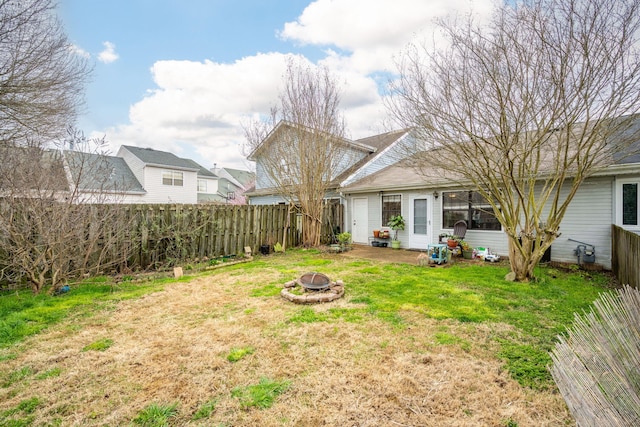 exterior space featuring an outdoor fire pit and fence