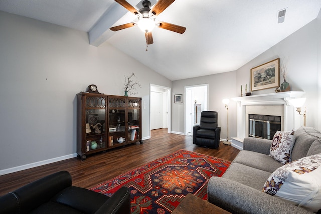 living room with vaulted ceiling with beams, wood finished floors, visible vents, baseboards, and a glass covered fireplace