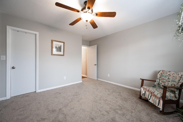 unfurnished room with carpet, ceiling fan, a textured ceiling, and baseboards