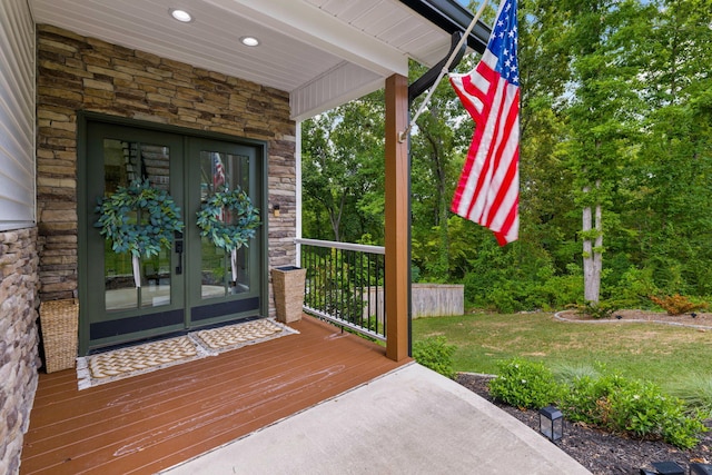 doorway to property featuring a yard and french doors