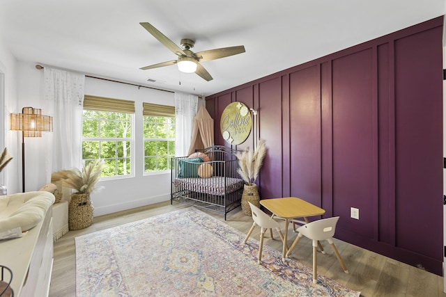 sitting room featuring light wood-type flooring and ceiling fan