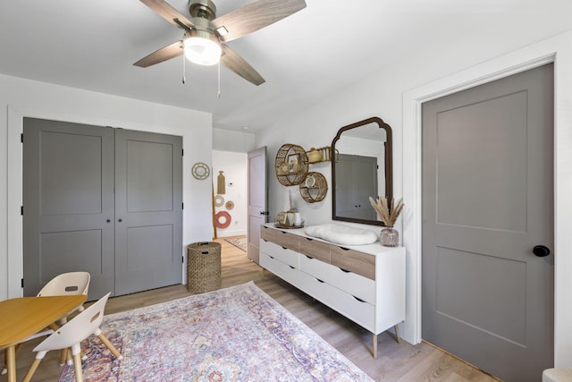 bedroom with a closet, hardwood / wood-style flooring, and ceiling fan