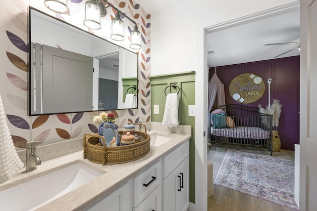 bathroom featuring ceiling fan, vanity, and wood-type flooring