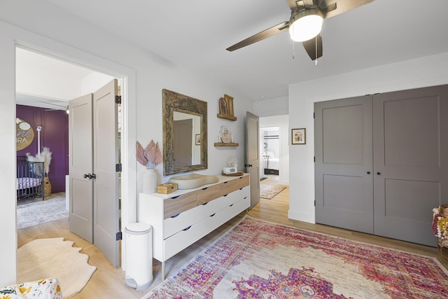 bathroom with hardwood / wood-style floors, ceiling fan, and vanity