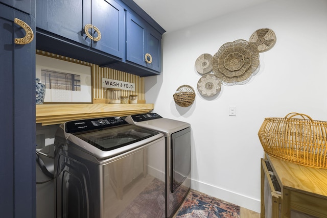 laundry area featuring cabinets and washing machine and dryer