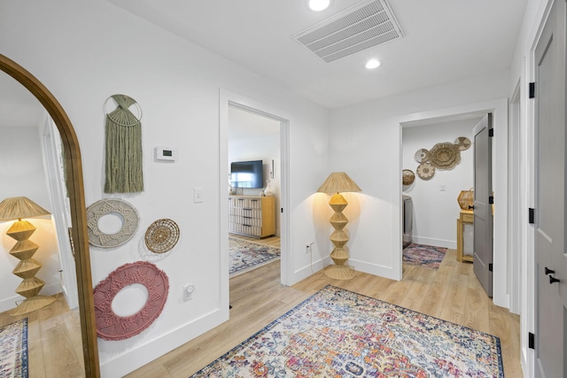 corridor with light hardwood / wood-style flooring