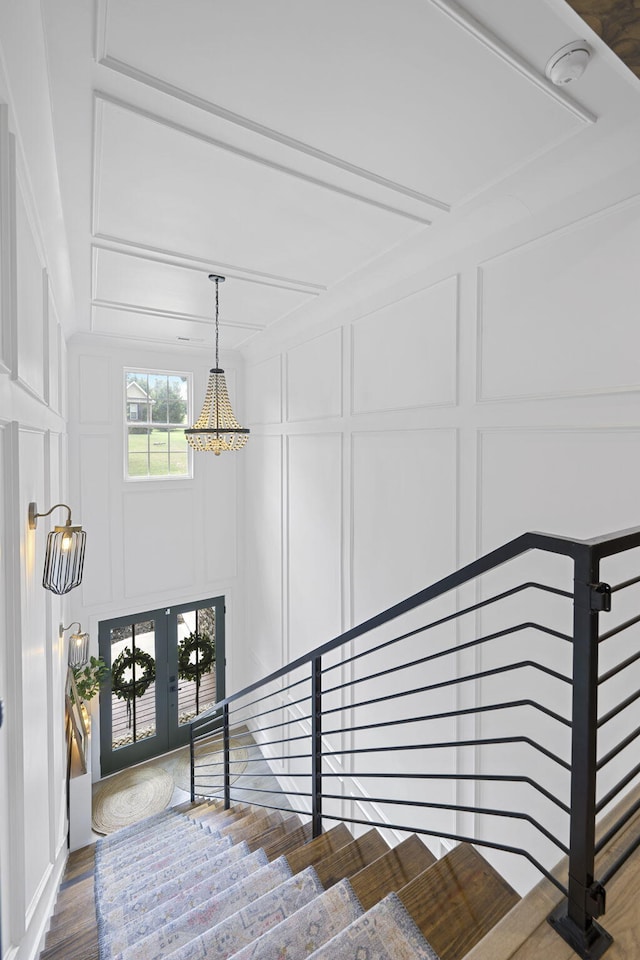 stairway featuring hardwood / wood-style floors and french doors