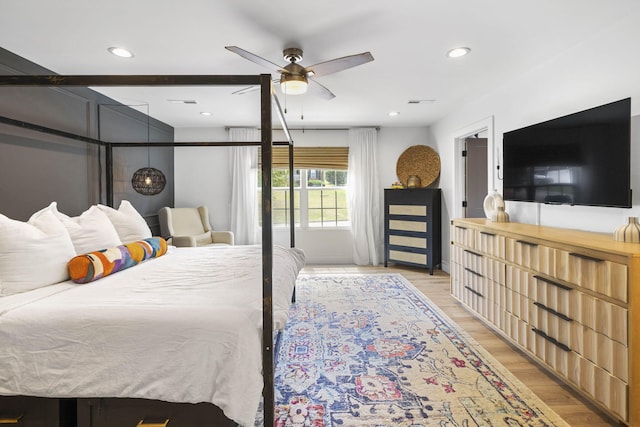 bedroom with ceiling fan and light hardwood / wood-style flooring