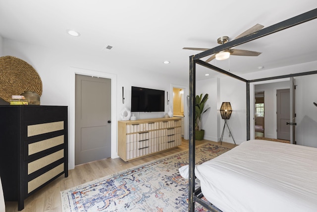 bedroom with ceiling fan and light hardwood / wood-style flooring