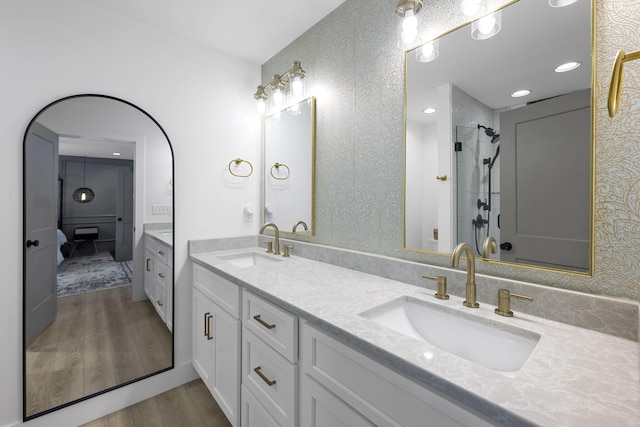 bathroom with vanity, wood-type flooring, and a shower