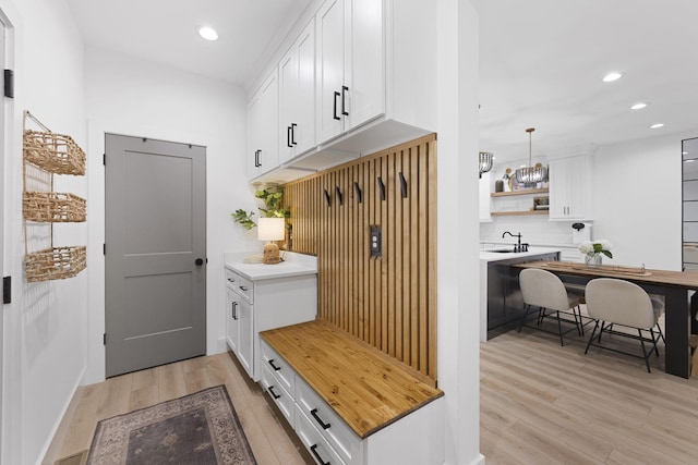 mudroom featuring sink and light hardwood / wood-style floors