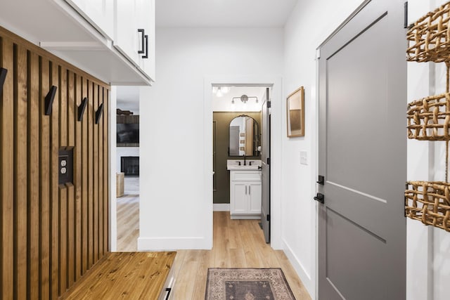 hallway featuring light hardwood / wood-style flooring and sink